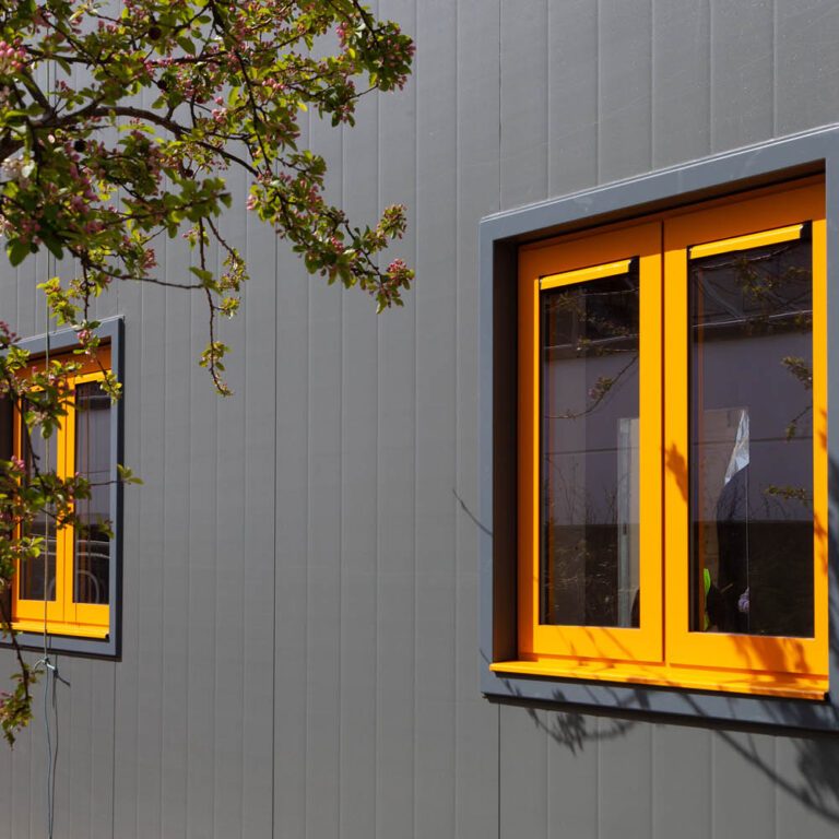 Outside of a building with a yellow window | modular healthcare buildings | Health Spaces