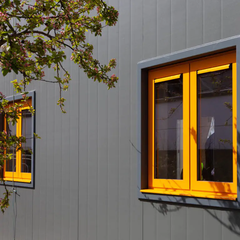 Outside of a building with a yellow window | modular healthcare buildings | Health Spaces
