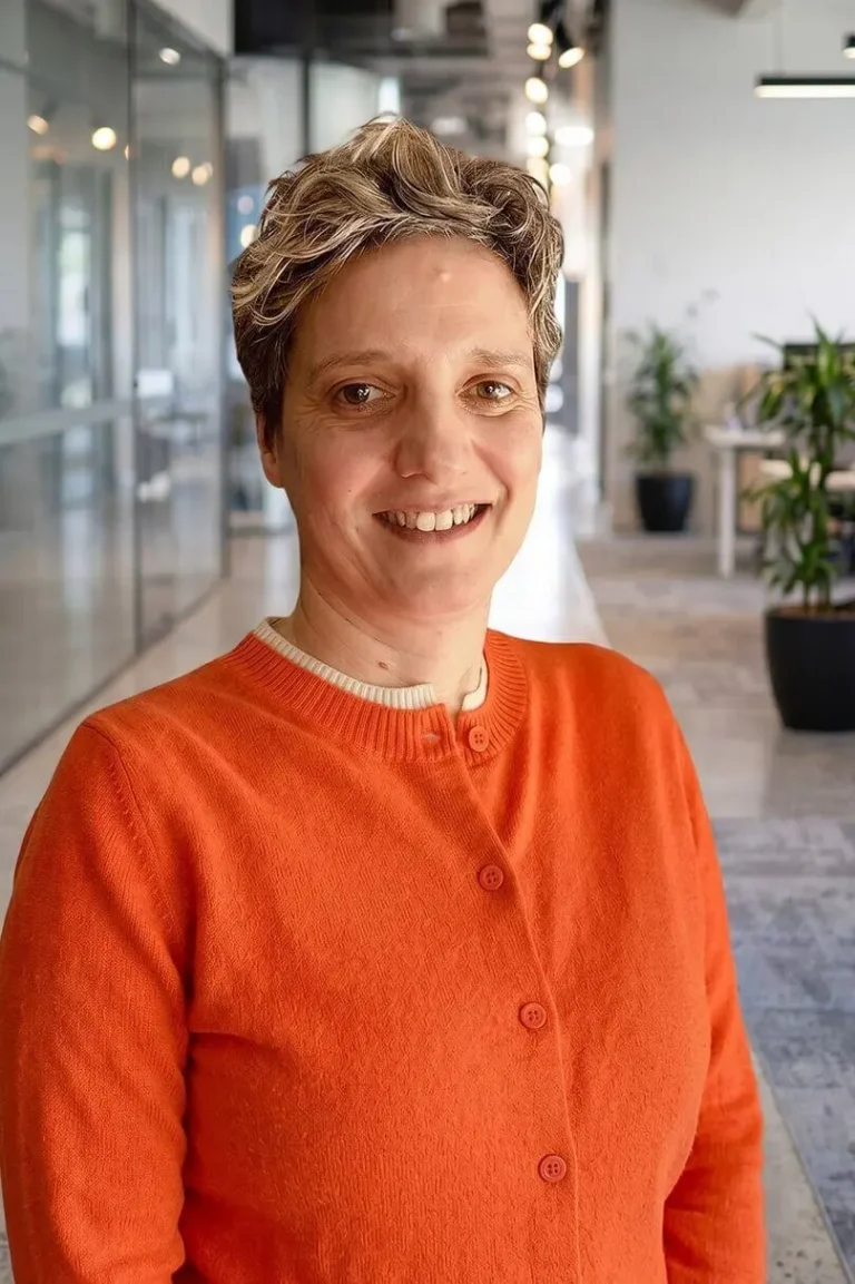 Portrait photo of Anthea Nelson , Group General Counsel stood in an open office