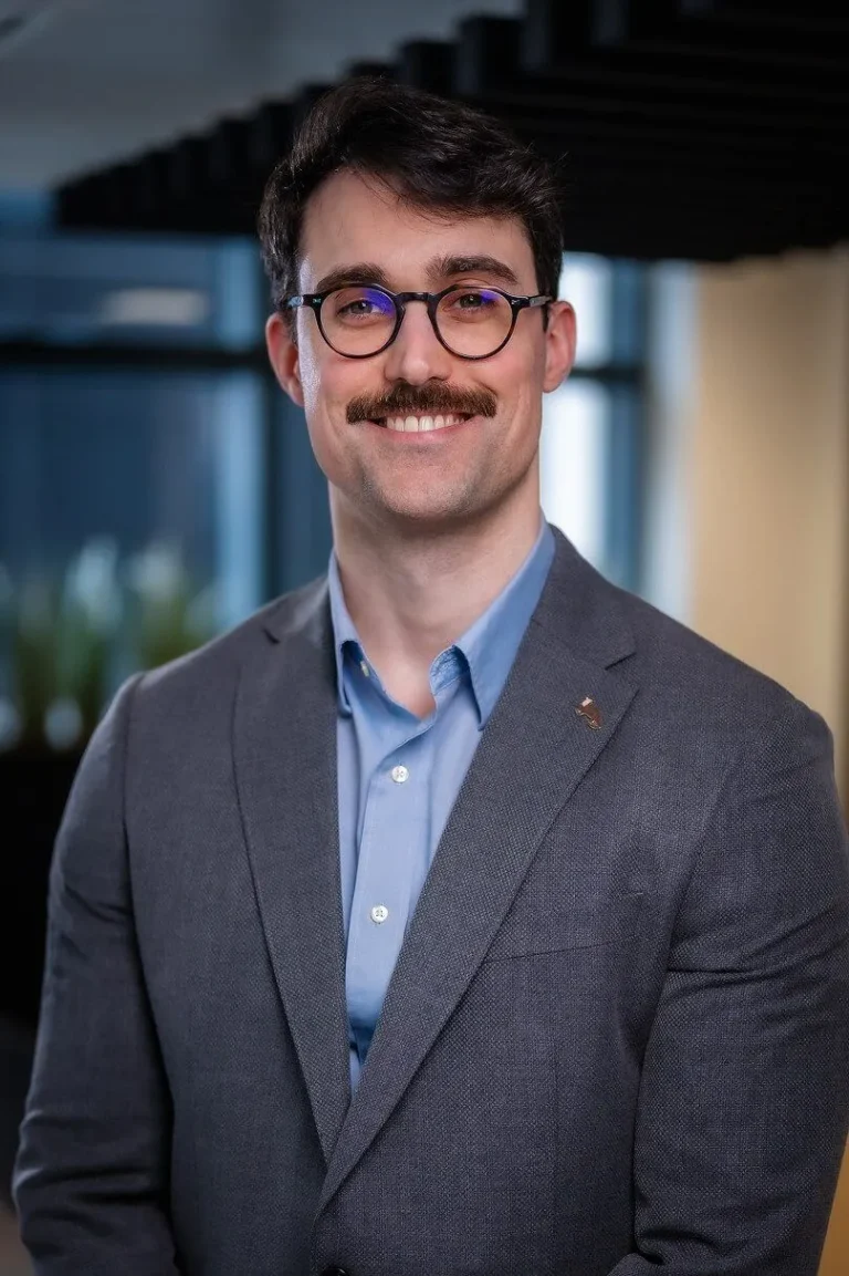 Portrait photo of Joseph Bonner, Bids & Tender Associate stood in an open office
