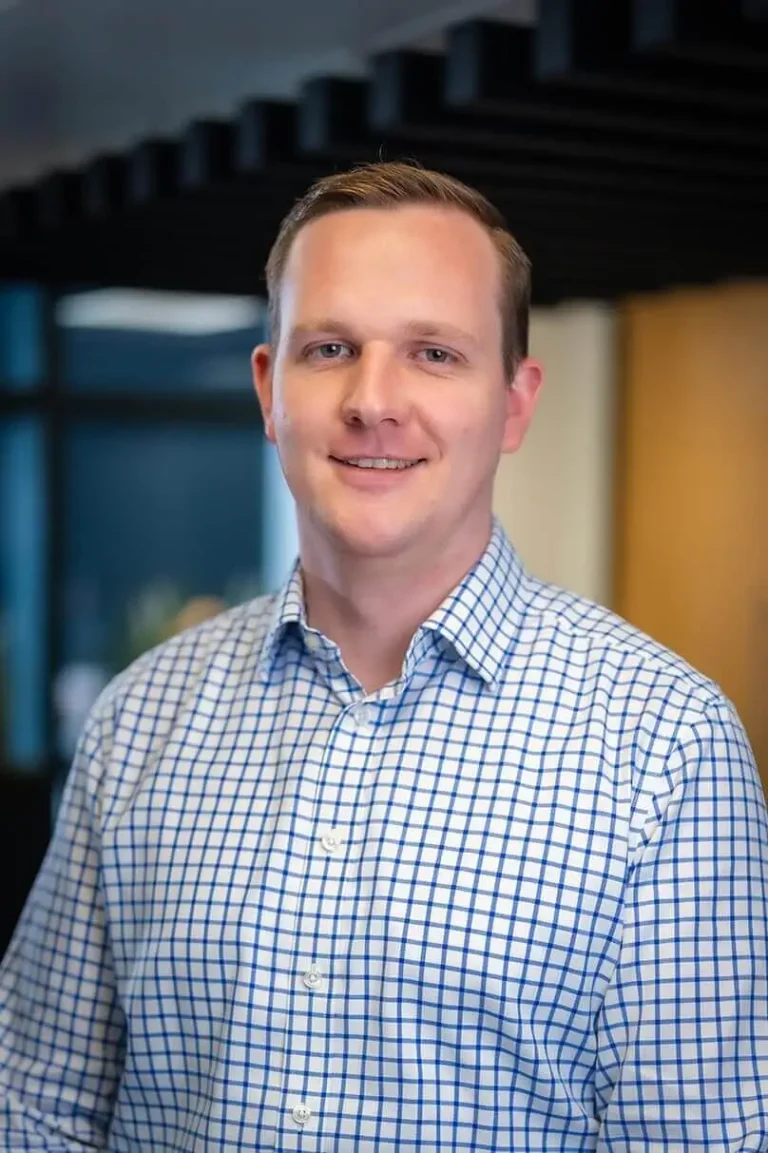 Portrait photo of Kelvin Moulding, Managing Director stood in an open office