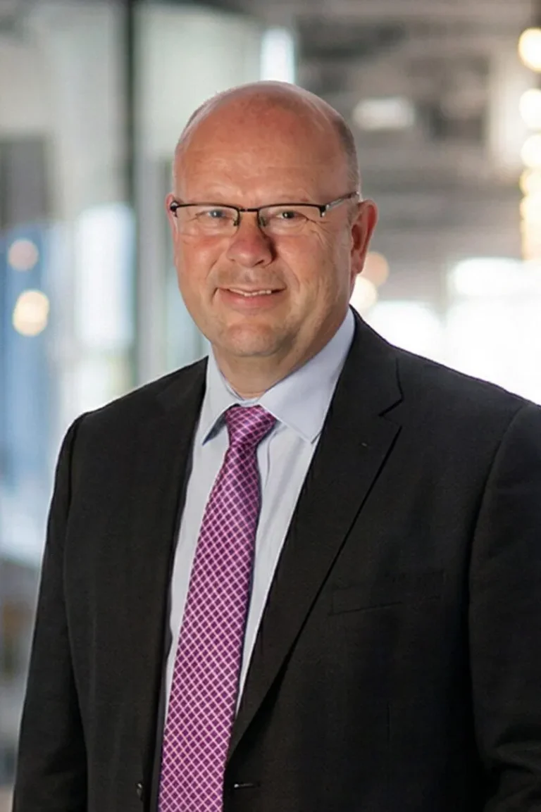 Portrait photo of Len Richards, Strategic Advisor stood in an open office